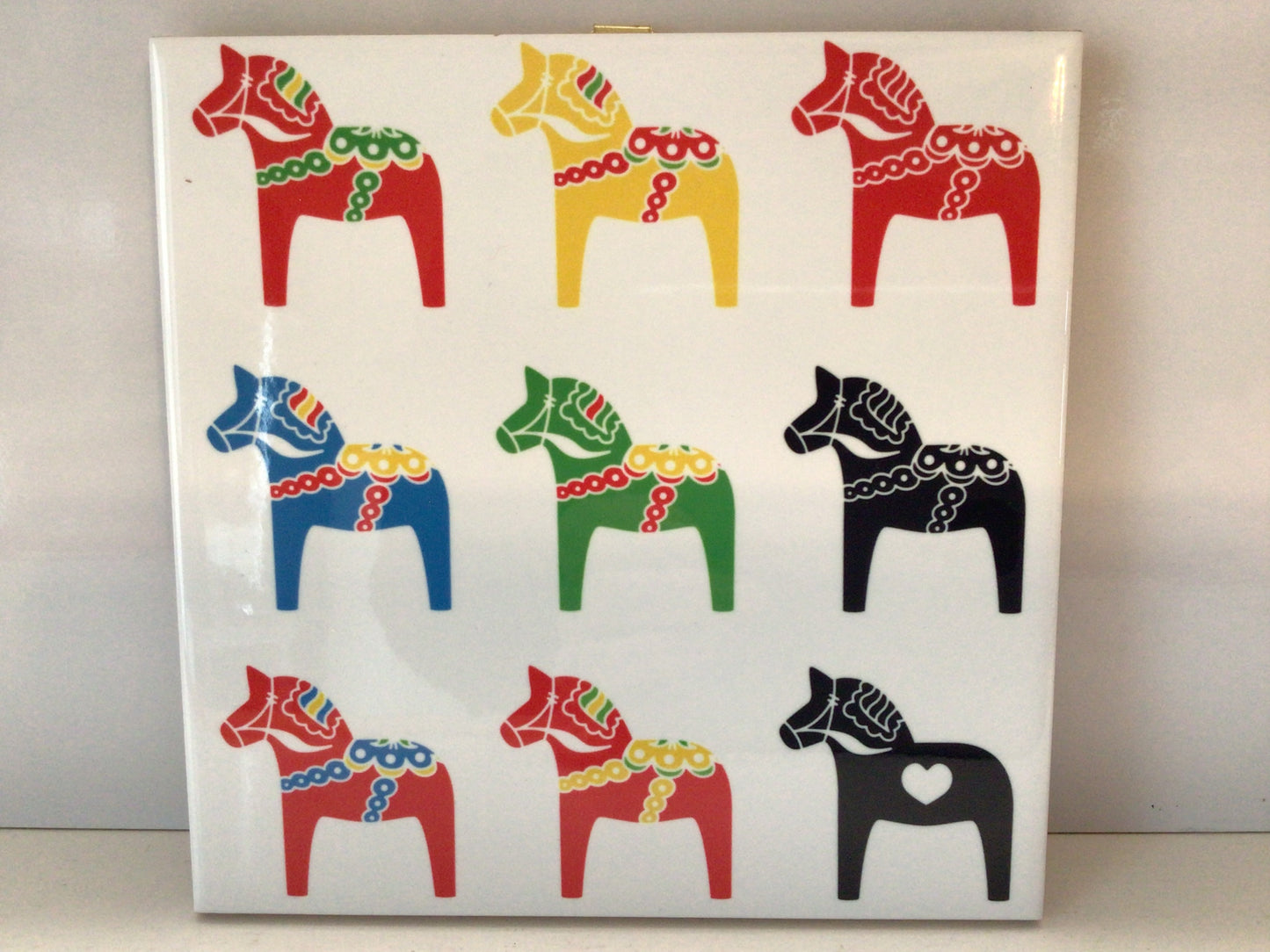 Nine Dalas on a Ceramic Tile